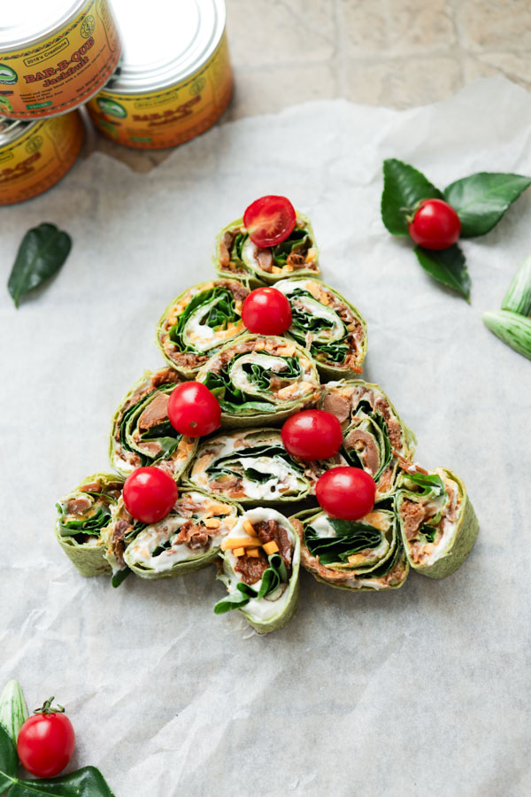 Whip up these BBQ Jackfruit Roll-ups for a festive and healthy holiday treat! This easy recipe transforms Nature's Charm BBQ Jackfruit into delicious, eye-catching Christmas tree-shaped appetizers. Perfect for parties, these vegan roll-ups with creamy cheese, crunchy spinach, and savory jackfruit are a crowd-pleaser. #VeganHoliday #HealthyAppetizers #JackfruitRecipes #FestiveFood
